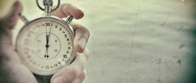 A hand holds a stopwatch.