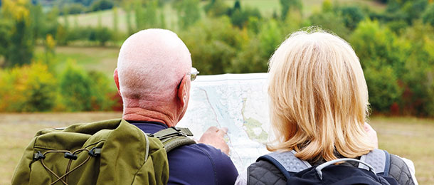 Older hikers look at a map.