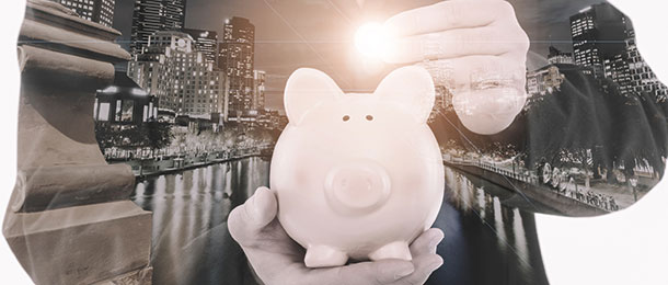 Piggy bank being held in a hand.