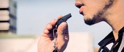 Referree blowing a whistle